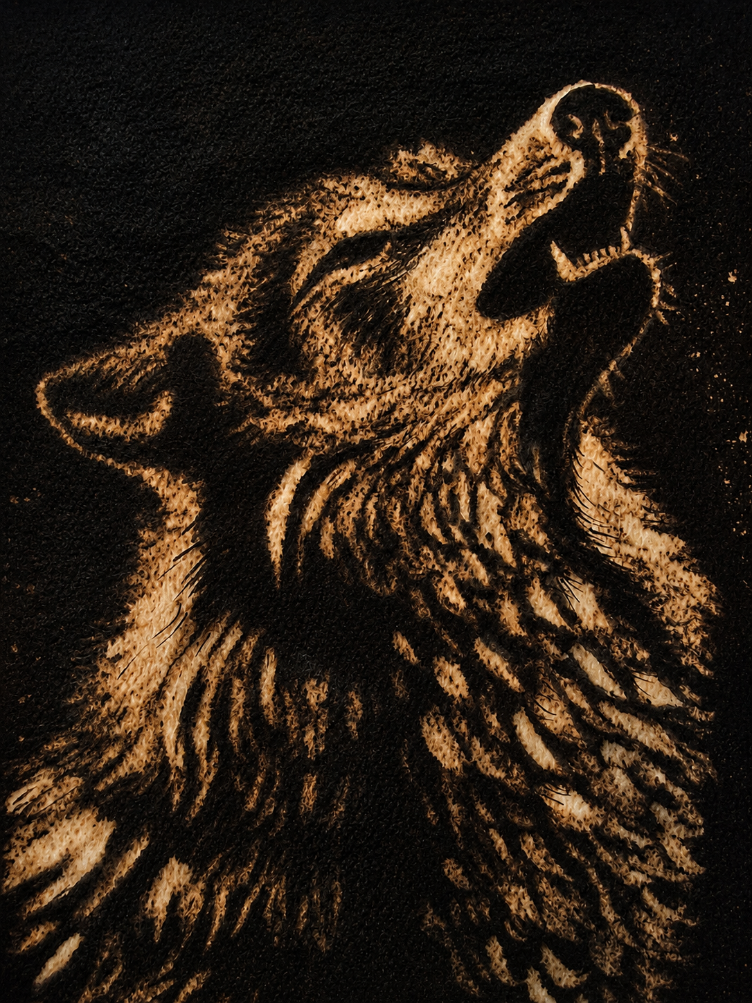 Sepia-toned portrait of a howling wolf